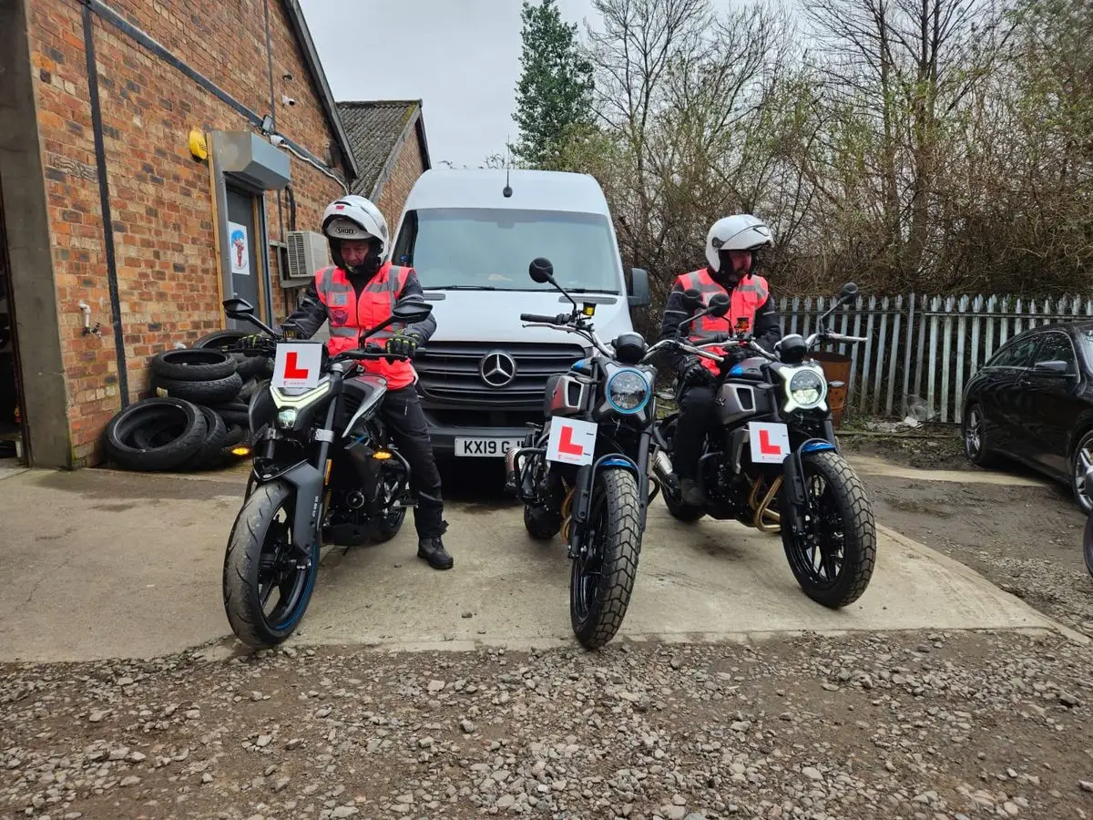 Instructors and training motorcycles outside the Edinburgh Motorcycle Training unit at Clippens Yard